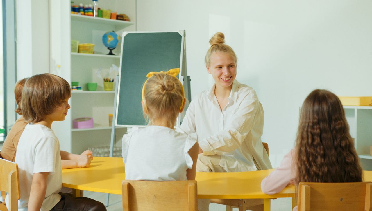 A teacher engaging with a child at For Kids' Sake
